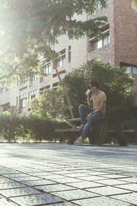 Full length of woman standing on tree trunk