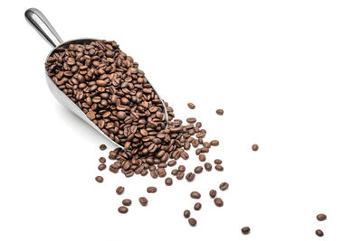 High angle view of coffee beans against white background