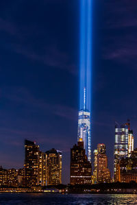 Illuminated cityscape against sky at night