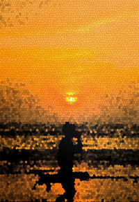 Silhouette man against sea during sunset