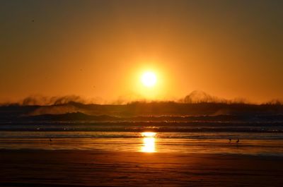 Scenic view of ocean at sunset