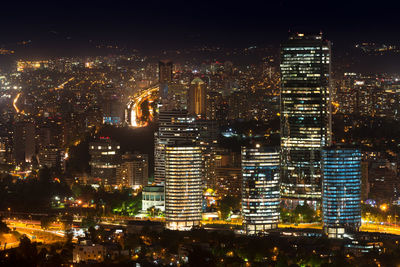 Illuminated cityscape against sky at night