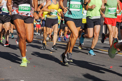 International marathon running race, people feet on city road
