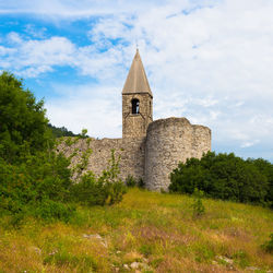 Historic building on field against sky