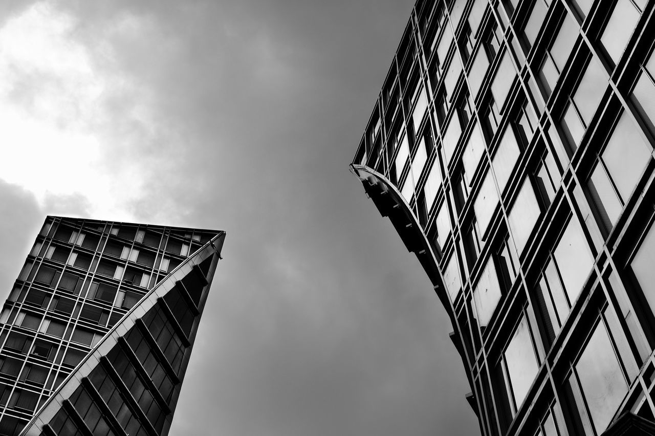 low angle view, architecture, built structure, building exterior, sky, tall - high, tower, modern, city, office building, cloud - sky, skyscraper, glass - material, building, cloudy, day, capital cities, cloud, reflection, outdoors