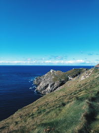 Scenic view of sea against blue sky