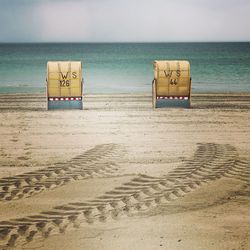 Lifeguard hut on beach against sky