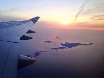 Cropped image of airplane flying over sea