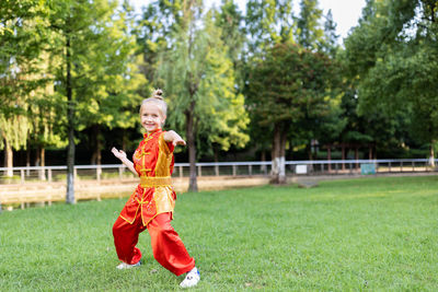 Full length of woman standing on field