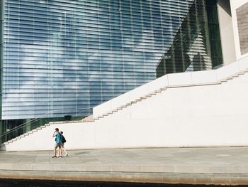 Full length of woman standing on steps