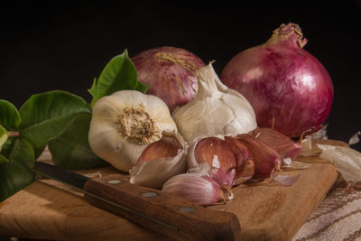 Close-up of chopped vegetables on table against black background