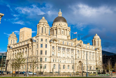 Low angle view of building against cloudy sky