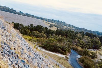 Scenic view of river by mountains against sky