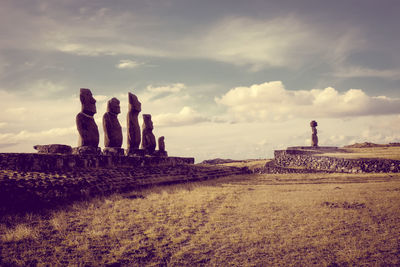 Built structure on landscape against cloudy sky