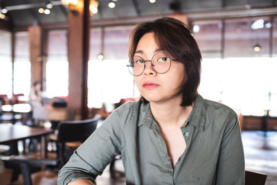 Portrait of young woman sitting at restaurant