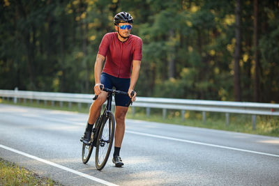 Man riding bicycle on road