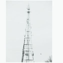 Low angle view of electricity pylon against sky