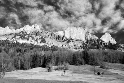 Scenic view of mountains against cloudy sky