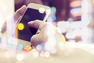 Double exposure of man using phone with city