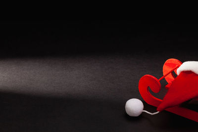 High angle view of heart shape on table against black background