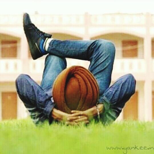 casual clothing, one man only, grass, one person, only men, jeans, adults only, relaxation, men, people, playing, full length, lying down, bale, adult, outdoors, day, nature, ball, cowboy hat, musical instrument