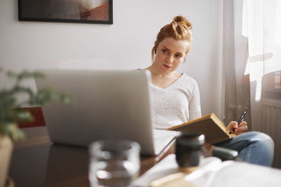 Woman using laptop at home