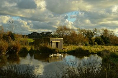 Scenic view of lake against cloudy sky