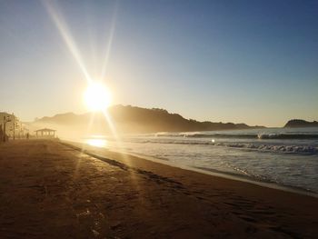 Scenic view of beach against sky during sunset