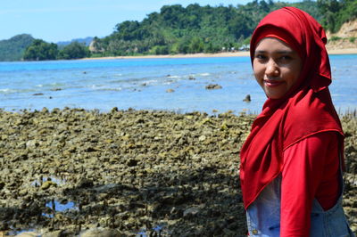 Portrait of woman standing on beach