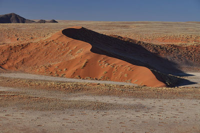 Sand dune in desert against sky