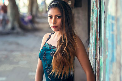 Portrait of beautiful woman standing at home