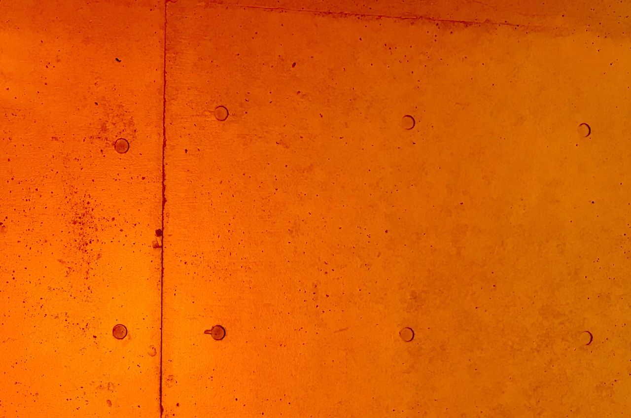 FULL FRAME SHOT OF ORANGE WALL WITH YELLOW BACKGROUND