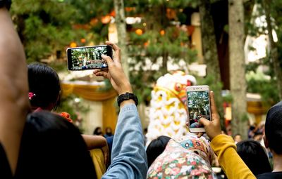 People photographing with mobile phones during festival