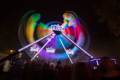 Low angle view of illuminated ferris wheel at night