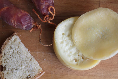 Top view of cheese, chorizo and a slice of bread