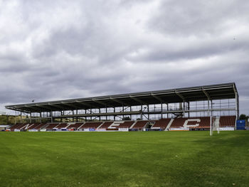 View of soccer field against cloudy sky