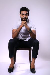 Portrait of young man sitting on seat