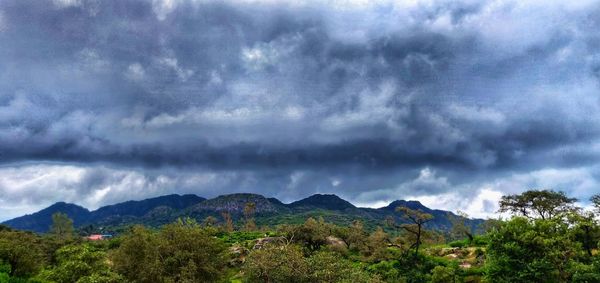 Scenic view of mountains against cloudy sky