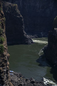 Scenic view of cliff and water in river