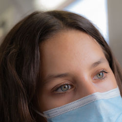 Close-up of young woman wearing mask