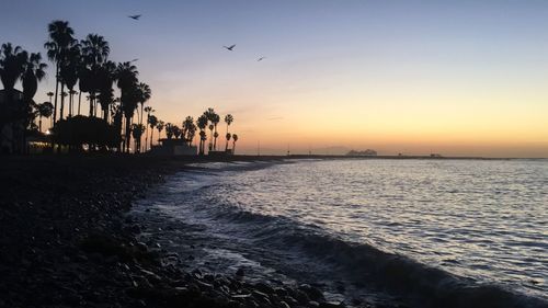 Scenic view of beach and sea against sky during sunset