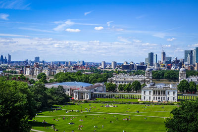 View of city buildings against cloudy sky