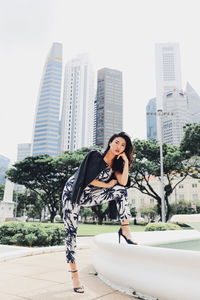 Full length of woman standing in city