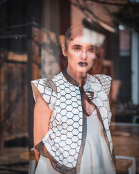 Portrait of woman seen through glass window