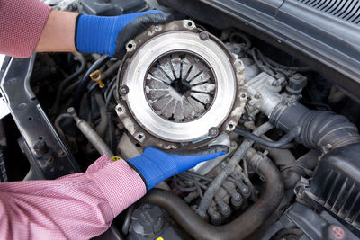 Midsection of man holding car