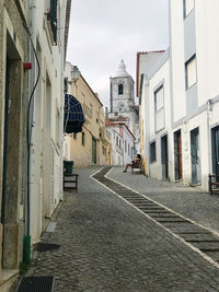 Empty alley amidst buildings in city