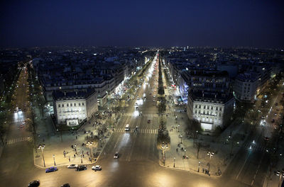 High angle view of city lit up at night