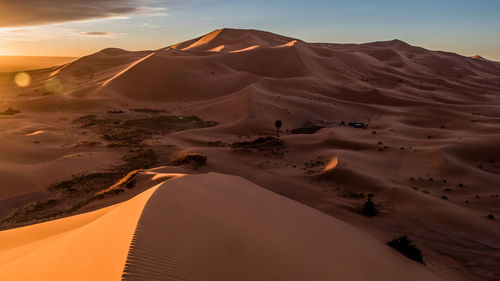 Scenic view of desert against sky during sunset