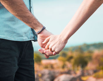 Close-up of cropped hand holding plant