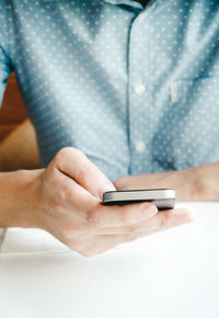 Midsection of woman using mobile phone